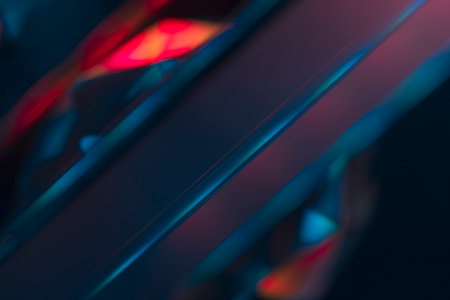 Overlay of a light leak coloured in red and cyan hues. Background is dark.の写真素材