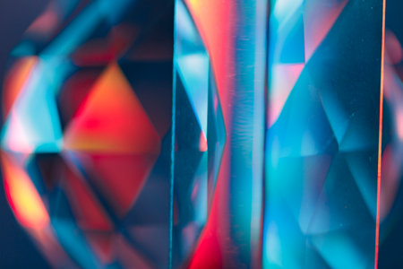 Overlay of a light leak coloured in red and cyan hues. Background is dark.の写真素材