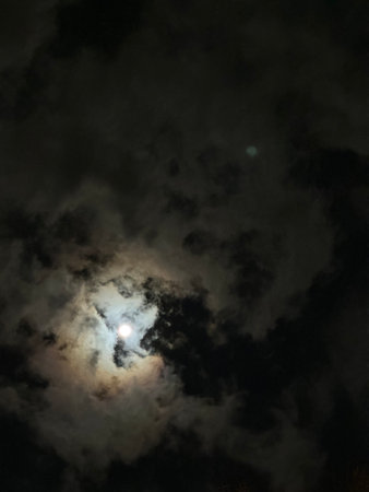 Full moon in the night sky with clouds and stars as background.の写真素材