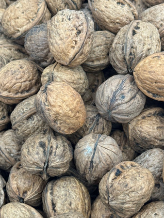 Close up of walnuts in a pile on a market stall.の写真素材