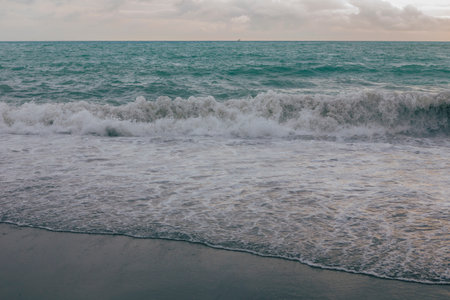 Beautiful seascape with sea waves on the sandy beach.