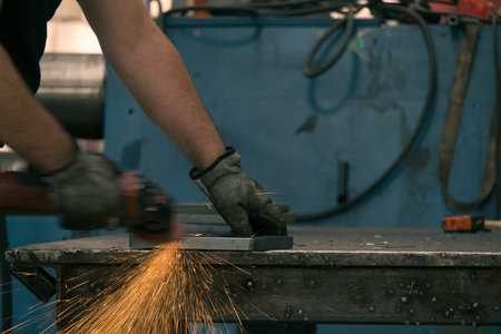 Detail of heavy industry manufacturing, sparks come out of a metal working welder.の写真素材