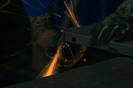 Detail of heavy industry manufacturing, sparks come out of a metal working welder.