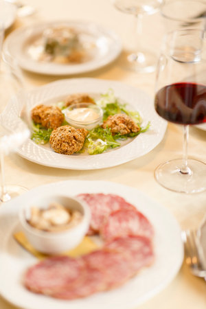 Close up on italian traditional northern food on a restaurant table.の写真素材