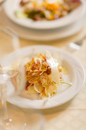 Close up on italian traditional northern food on a restaurant table. Many dishes are visible.の写真素材