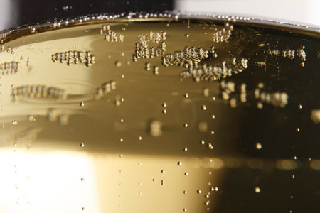 Macro shot of Champagne sparkling in a wine glass, background is blurred.の写真素材