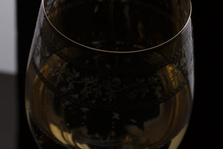 Macro shot of Champagne sparkling in a wine glass, background is blurred.