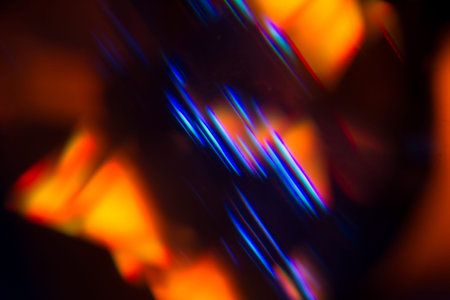 Colorful light leak on black background, abstract with optical lens flare shot on a true photo lens.