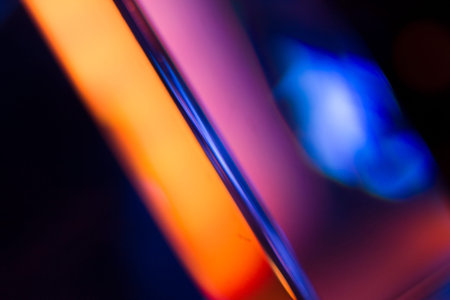 Colorful light leak on black background, abstract with optical lens flare shot on a true photo lens.の写真素材