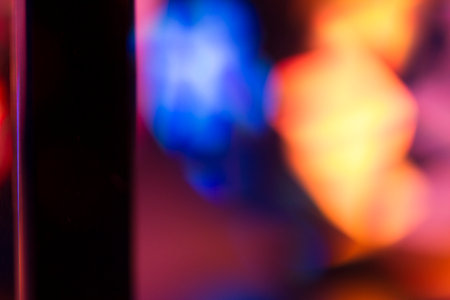 Colorful light leak on black background, abstract with optical lens flare shot on a true photo lens.の写真素材