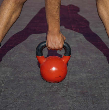 man taking crossfit kettlebellの写真素材