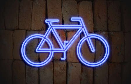 neon sign with bicycle symbol on brick wallの写真素材