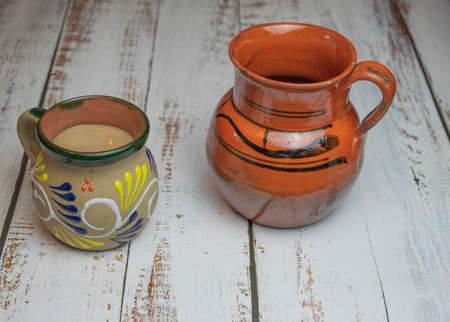 Classic Mexican style clay cups for coffee on wooden tableの写真素材