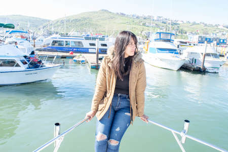 beautiful mexican woman sitting on boat in the seaの写真素材