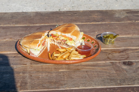 Mexican style Hawaiian torta with French fries and tomato sauce (mexican burger)の写真素材