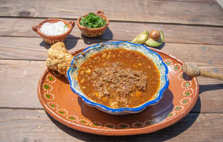 mexican food with birria, hot sauce and chicharron with and avocados, onion and corianderの写真素材