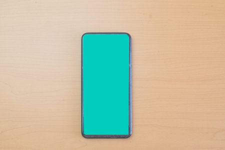 mobile phone mockup on wooden desk
