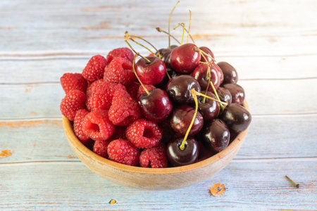 fresh cherry and raspberries in rustic bowl
