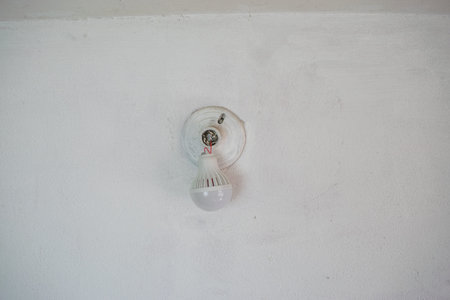 Damaged bulb hanging from socket. electrical repair