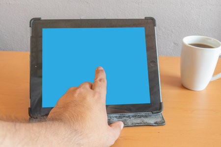 tablet mockup with editable screens. on desk with coffee