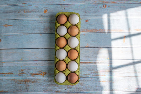 top view of organic brown and white eggs in biodegradable container