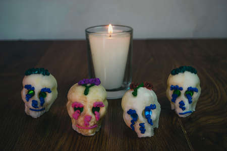 altar with candle lit next to sugar skulls, decoration for the day of the dead. Mexican festivityの写真素材