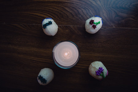 altar with candle lit next to sugar skulls, decoration for the day of the dead. mexican tradition