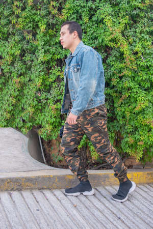 Young handsome man model with urban style with camouflage trousersの写真素材
