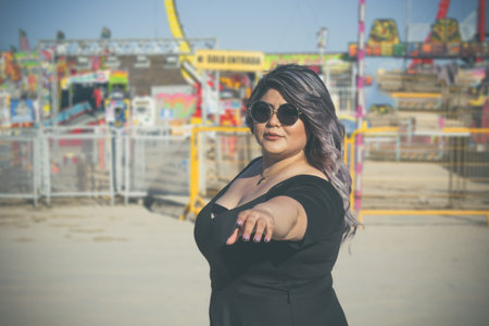 beautiful and fashion overweight woman enjoying a day at the fair. Hispanic model