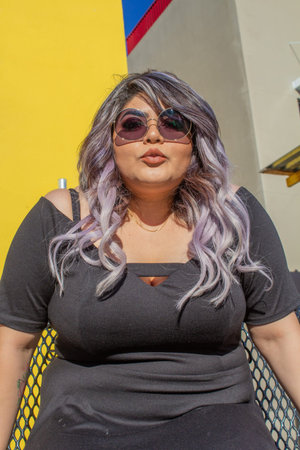 beautiful chubby model with professional makeup sending a kiss to the camera. latin woman