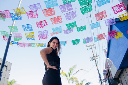 Mexican woman on colorful street with Mexican party decorations