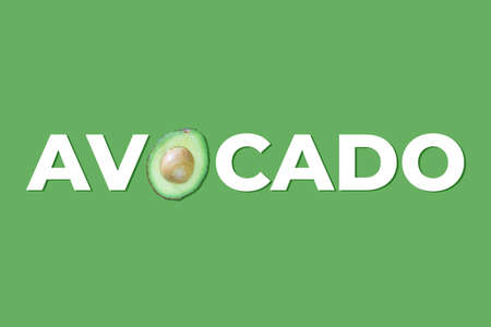 banner with avocado word written with real avocado on green backgroundの写真素材