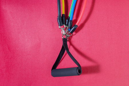 close up of different colored resistance bands with handle, for exercise