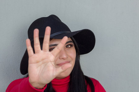 Mexican woman making the give me five sign with her hand. young hispanicの写真素材