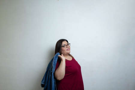 fat fashion model showing outfit with denim jacket, plus size womanの写真素材