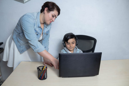 teacher giving private lesson to little student on laptop. mexican kid