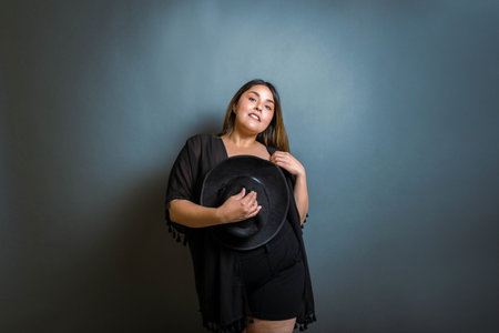 beautiful and sensual mexican woman with fedora hatの写真素材