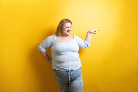 fat young caucasian model pointing asideの写真素材