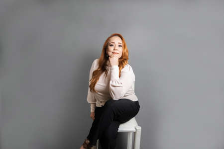 beautiful and mature elegant Caucasian Latina business woman sitting on chair looking at cameraの写真素材