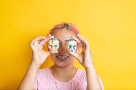Mexican woman covering her eyes with catrinas. Day of the Dead. sugar skull for offeringの写真素材