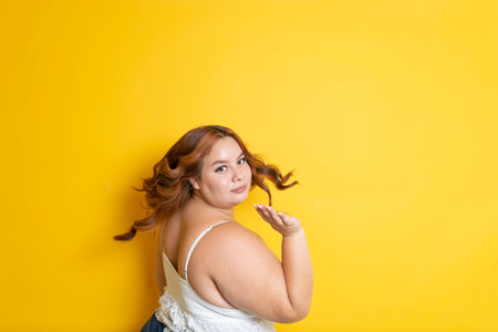 portrait of redhead plus size model playing with her hair and making it float