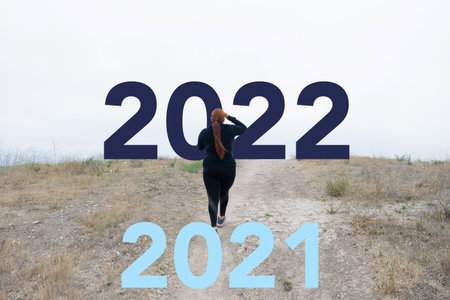 woman running on hill from 2021 to 2022. New year concept