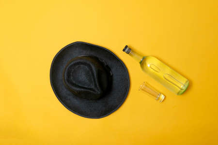 top view of bottle of tequila mezcal or vodka with shot glassの写真素材