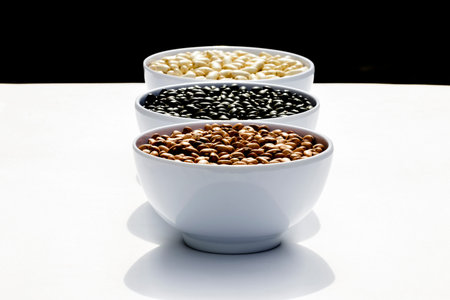 varieties of beans in bowls, white backgroundの写真素材