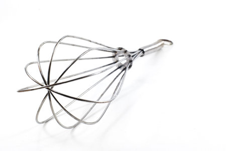 Stainless steel whisk isolated on white background