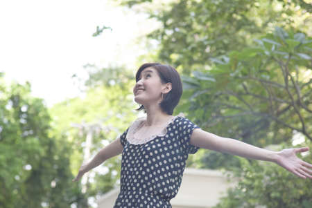 beautiful asian young woman spread her arms wide openの写真素材