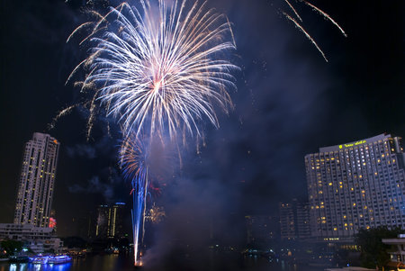 BANGKOK-Jan 01:The happy new year 2011 exploding fireworks over chaophraya river in bangkok Thailand...