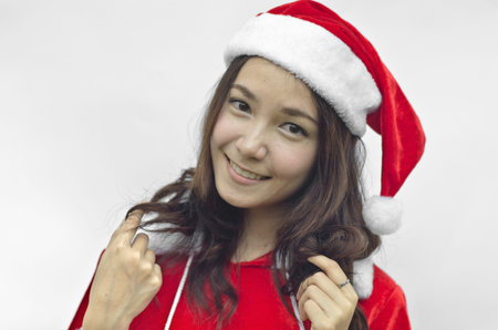 Beautiful young santa clause woman in christmas clothes smiling . isolated on white backgroundの写真素材