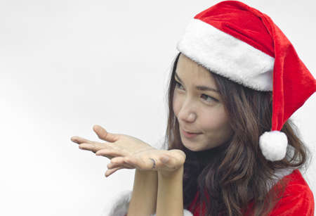 Beautiful young santa clause woman in christmas clothes smiling . isolated on white backgroundの写真素材