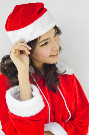 Beautiful young santa clause woman in christmas clothes smiling . isolated on white backgroundの写真素材